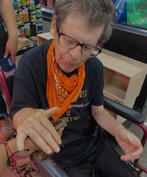 Adult Male Petting a Baby Chick